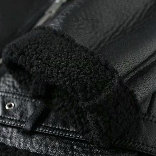 Close-up of a black leather jacket with textured trim