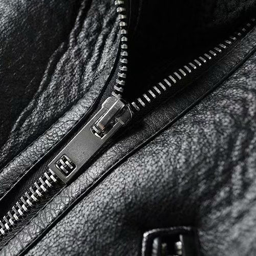 Close-up of a black leather bag with a zipper