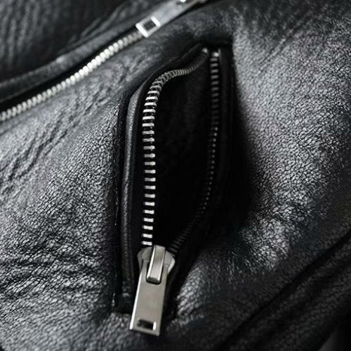 Close-up of a black leather bag with a zipper