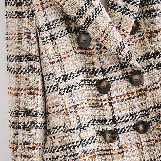 Plaid patterned coat with buttons on a white background