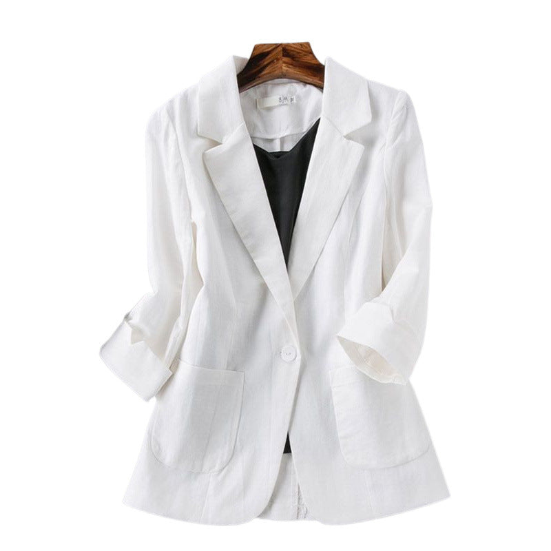 White blazer on a wooden hanger against a white background